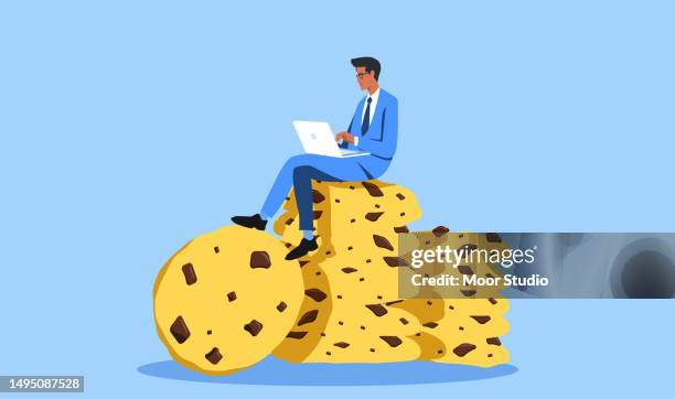 man working on laptop sitting on a stack of cookies vector illustration - browser history stock illustrations