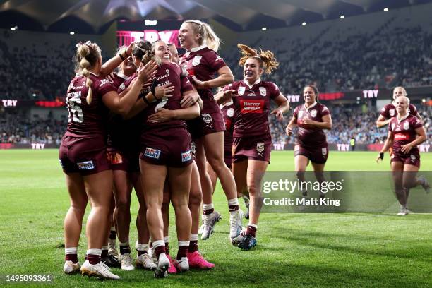 Julia Robinson of the Maroons celebrates with team mates after scoring a try during game one of the Women's State of Origin series between New South...