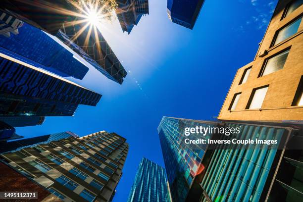 low angle scene view of the skyscrapers in melbourne city in cbd or central business district under the blue sky - southbank imagens e fotografias de stock