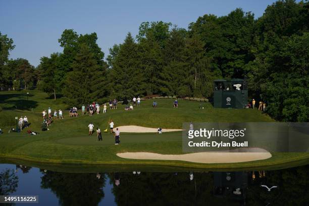 Byeong Hun An of South Korea, Denny McCarthy and Patrick Rodgers of the United States on the 12th green during the first round of the Memorial...