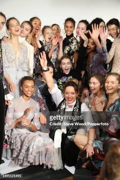 Backstage at the Temperley show during London Fashion Week Autumn/Winter 2016/17, Alice Temperley poses with her models, all wearing long evening...