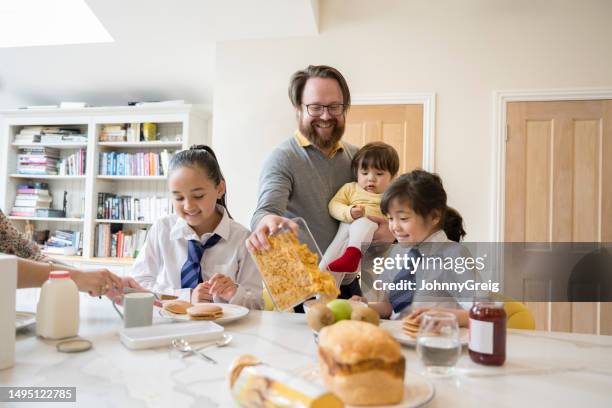 multiracial family enjoying breakfast together - korean ethnicity stock pictures, royalty-free photos & images