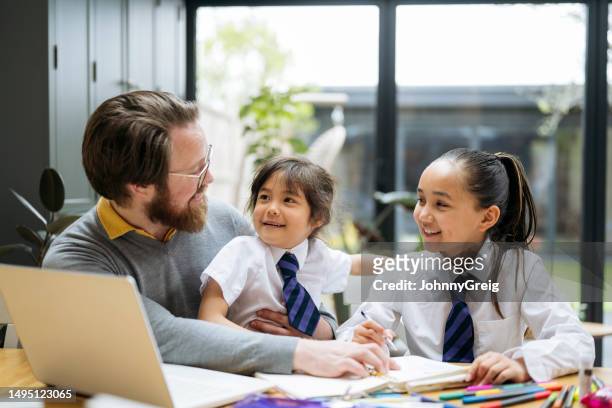 bearded dad spending time with elementary age daughters - parent school child stock pictures, royalty-free photos & images