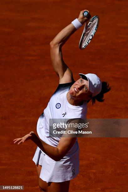 Iga Swiatek of Poland serves against Claire Liu of United States during the Women's Singles Second Round match on Day Five of the 2023 French Open at...