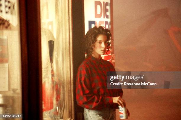 American actress Jami Gertz stands next to a Diet Pepsi vending machine ready to be filmed for a Diet Pepsi television commercial wearing a red plaid...