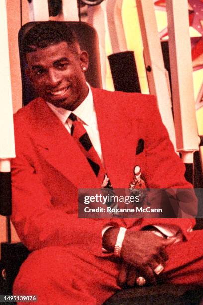 Professional NFL and MLB player Deion Sanders, on the Atlanta Braves and Atlanta Falcons teams, sits on exercise equipment on the set of a Nike...