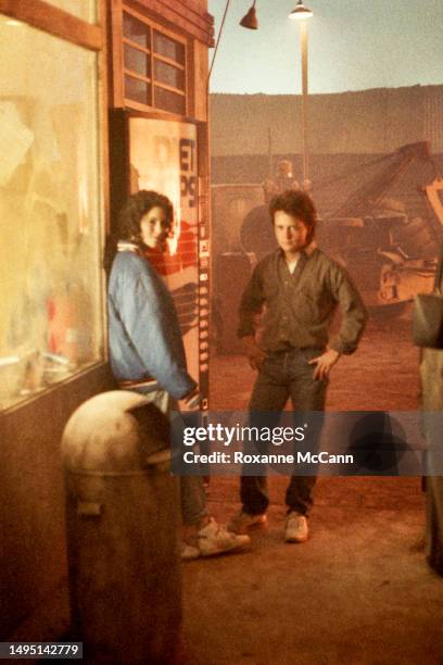 American actors Jami Gertz and Michael J. Fox stand by a Diet Pepsi vending machine ready to be filmed for a Diet Pepsi television commercial wearing...