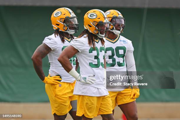 Aaron Jones, Tyler Goodson and Lew Nichols of the Green Bay Packers participate in an OTA practice session at Don Hutson Center on May 31, 2023 in...