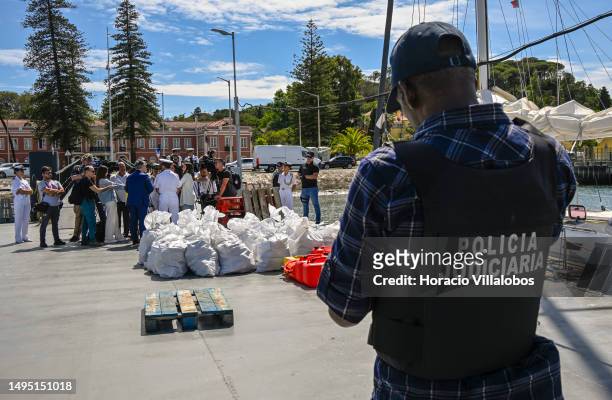 Members of the Judiciary Police stand near sacks containing cocaine while Naval Commander of the Portuguese Navy Vice-Admiral Nuno Chaves Ferreira...