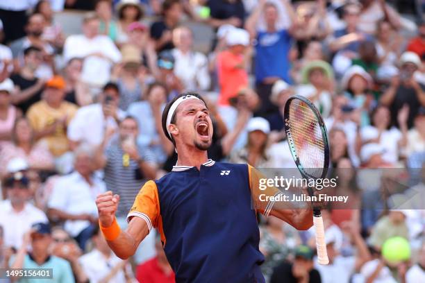 Daniel Altmaier of Germany celebrates winning match point against Jannik Sinner of Italy during the Men's Singles Second Round match on Day Five of...