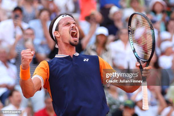 Daniel Altmaier of Germany celebrates winning match point against Jannik Sinner of Italy during the Men's Singles Second Round match on Day Five of...