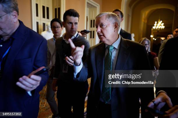 Sen. Lindsey Graham is surrounded by reporters as he leaves the offices of Senate Minority Leader Mitch McConnell following a meeting at the U.S....