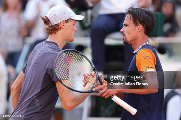 Jannik Sinner of Italy shakes hands with Daniel Altmaier of Germany after the Men's Singles Second Round match on Day Five of the 2023 French Open at...