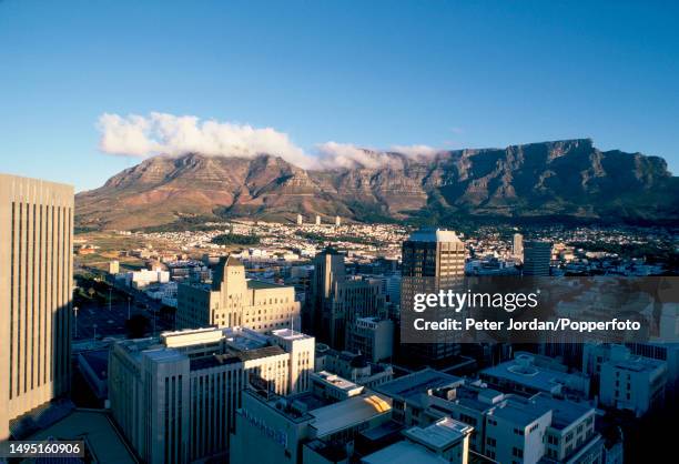 Aerial view of the downtown central business district of the city of Cape Town and, behind, Table Mountain in Cape Province in South Africa in June...