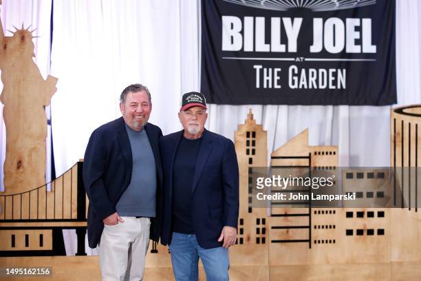Billy Joel listens as James Dolan speaks as MSG Entertainment and Billy Joel make a special franchise announcement at Chase Square at Madison Square...