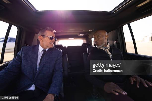 businessmen inside luxury suv - luxury 4x4 stock pictures, royalty-free photos & images