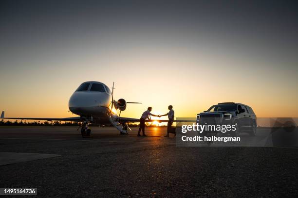 pilot shaking hands with wealthy passenger - luxury car stock pictures, royalty-free photos & images