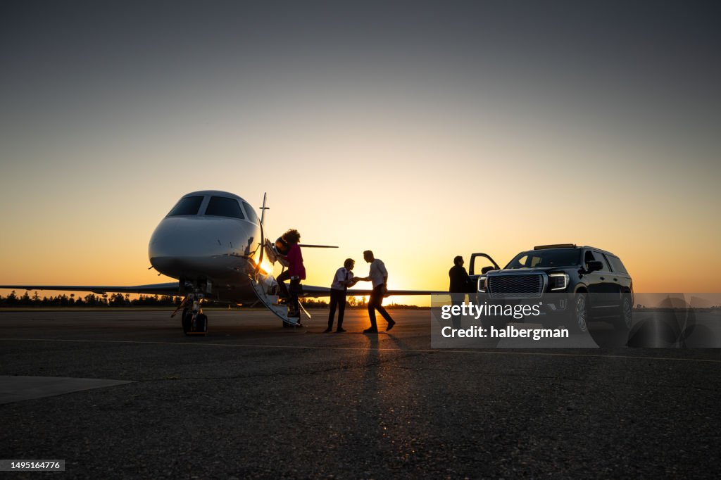 Pilot Welcoming Passengers Into Private Jet