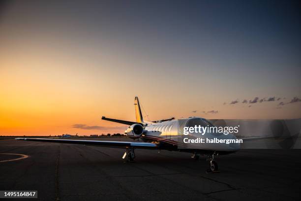 white private plane on runway - private aeroplane stock pictures, royalty-free photos & images