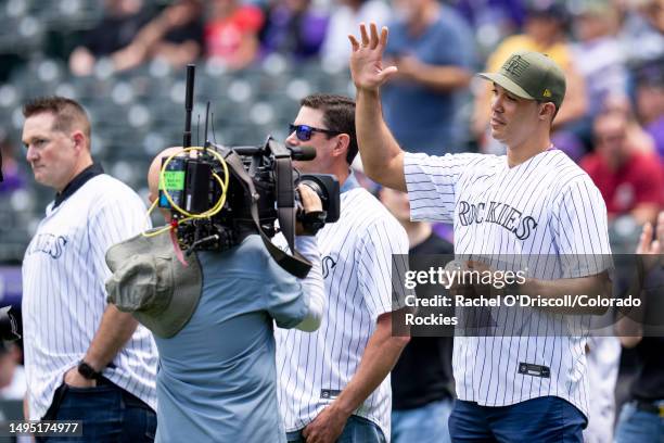 Former Colorado Rockies pitcher Ubaldo Jimenez waves to the crowd during a pre game ceremony ahead of a game between the Colorado Rockies and the New...