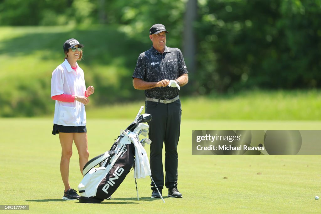 Stewart Cink of the United States and his caddie plan a shot on the ...