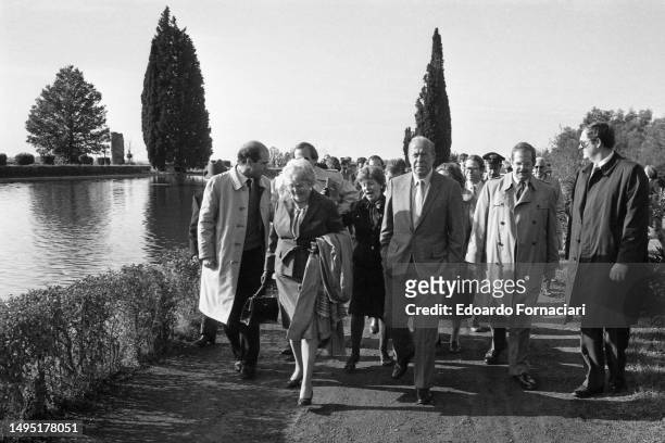 Secretary of State George Shultz and others walk along the reflecting pool at Villa Adriana , Tivoli, Italy, December 13, 1982.