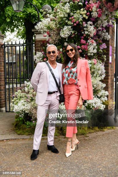 Bruno Tonioli wears a Pink suit, white T shirt, Ray Ban sunglasses, Saint Laurent boots and an Aspinal of London bag with Lauren Silverman wearing...