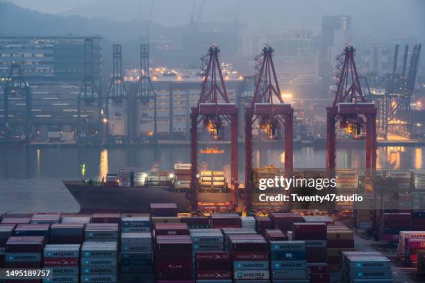 cranes loading containers at a port - global economy stock pictures, royalty-free photos & images