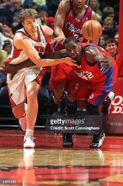 Hanno Mottola of the Atlanta Hawks and Elton Brand of the Los Angeles Clippers battle for a loose ball at Philips Arena in Atlanta, Georgia. Digital...
