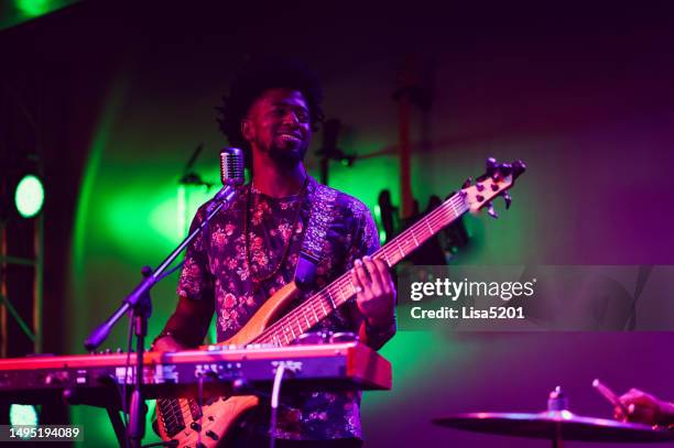 musician performing on stage with guitar - passion stock pictures, royalty-free photos & images