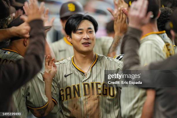 Ha-Seong Kim of the San Diego Padres is congratulated by teammates after scoring in the sixth inning against the Miami Marlins at loanDepot park on...