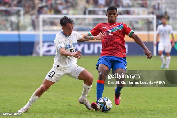 Franco Gonzalez of Uruguay battles for the ball with Ba Lamin Sowe of Gambia during a FIFA U-20 World Cup Argentina 2023 Round of 16 match between...