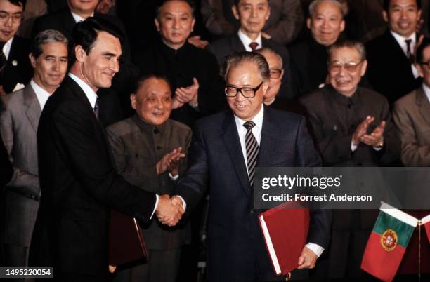 Portuguese Prime Minister Aníbal Cavaco Silva and Chinese Premier Zhao Ziyang shake hands after signing a joint resolution, Beijing, China, April 13,...
