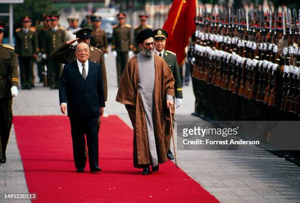 Chinese President Yang Shangkun and Iranian President Ali Khameneyi walk together during a welcoming ceremony for the latter's State Visit, Beijing,...