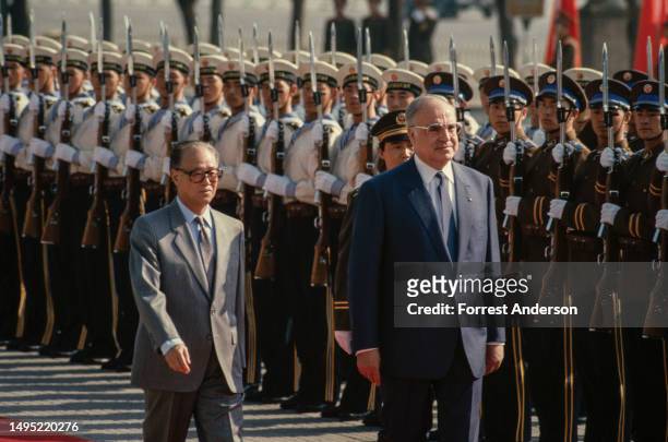 Chinese Premier Zhao Ziyang and German Chancellor Helmut Kohl walk together during a welcoming ceremony for the latter's State Visit, Beijing, China,...