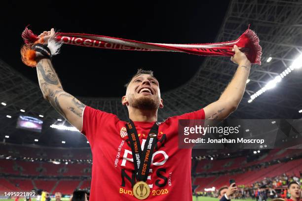 Lucas Ocampos of Sevilla celebrates in fornt of fans following the penalty shoot out victory in the UEFA Europa League 2022/23 final match between...