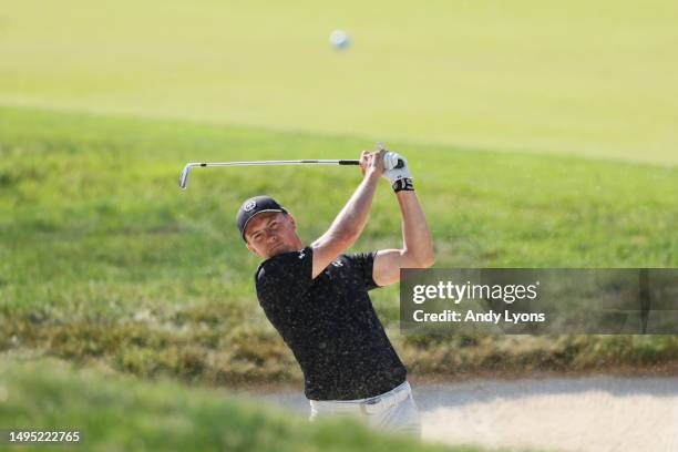 Jordan Spieth of the United States plays a shot from a bunker on the 18th hole during the first round of the Memorial Tournament presented by Workday...