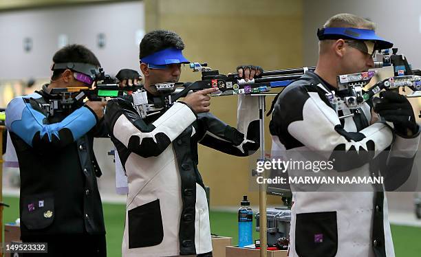 India's Abihinav Bindra competes in the 10m Air Rifle men qualifying round at the Royal Artillery Barracks in London on July 30, 2012 during the...