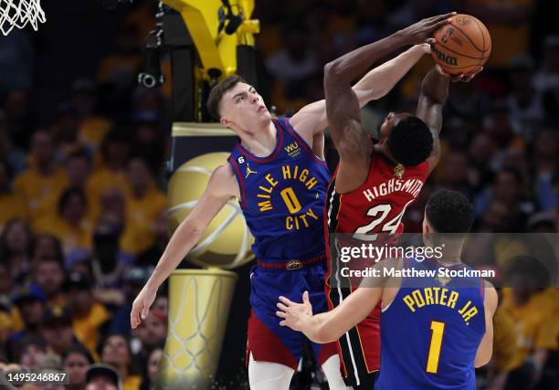 Christian Braun of the Denver Nuggets blocks a shot by Haywood Highsmith of the Miami Heat during the second quarter in Game One of the 2023 NBA...