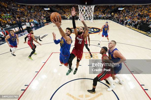Jamal Murray of the Denver Nuggets drives to the basket against Caleb Martin of the Miami Heat during the first half in Game One of the 2023 NBA...