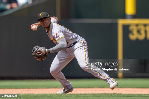 Third baseman Ke'Bryan Hayes of the Pittsburgh Pirates throws to first base after fielding a ground ball during a game against the Seattle Mariners...