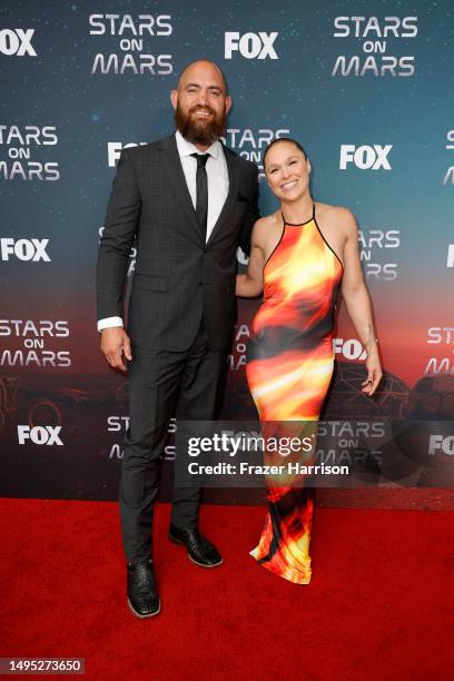 Travis Browne and Ronda Rousey attend FOX's Stars On Mars "The Mars Bar" VIP red carpet press preview at Scum and Villainy Cantina on June 01, 2023...