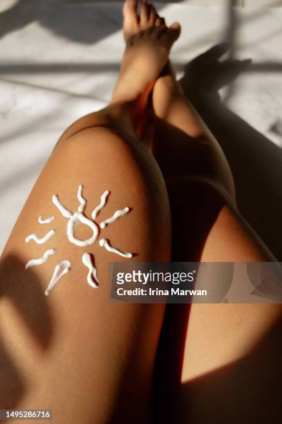 woman using sunscreen. sunscreen application - tanned body stock pictures, royalty-free photos & images