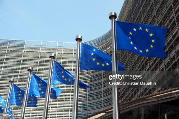 european commission, european flags at berlaymont building. - europäische kulturhauptstadt stock-fotos und bilder