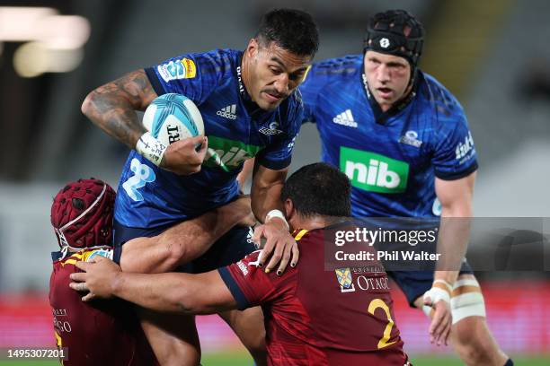 Rieko Ioane of the Blues is tackled during the round 15 Super Rugby Pacific match between Blues and Highlanders at Eden Park, on June 02 in Auckland,...