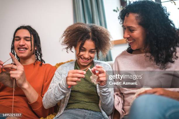 young mix raced siblings learning crocheting and knitting - raced stock pictures, royalty-free photos & images