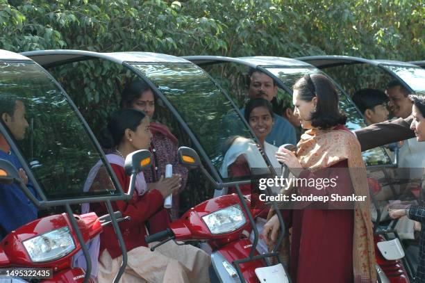 Unied Progressive Alliance chairperson Sonia Gandhi distributing motorised vehicles to disabled person from different parts of India at her residence...