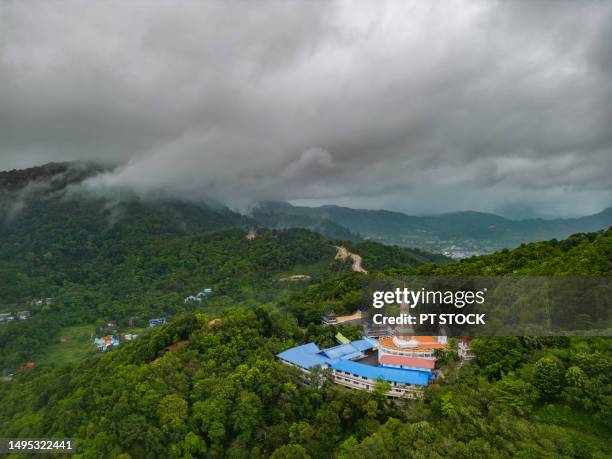 doi thep nimit monastery in phuket, thailand where the white pagoda sits on a mountain with mist in the background. - trust god stock pictures, royalty-free photos & images