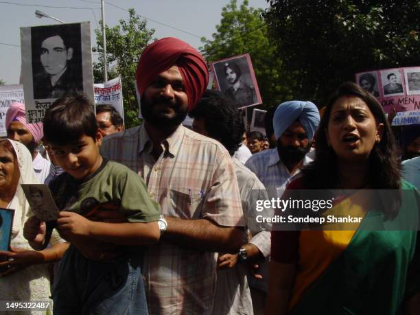 Member of Parliament Navjot Singh Sidhu with actress Smriti Irani during a peace rally in New Delhi on Sunday, October 02,2005 demanding release of...