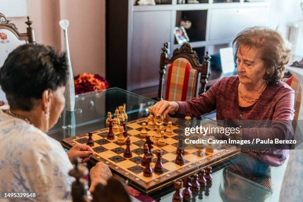 two elderly women playing a board game - fashionable grandma stock pictures, royalty-free photos & images